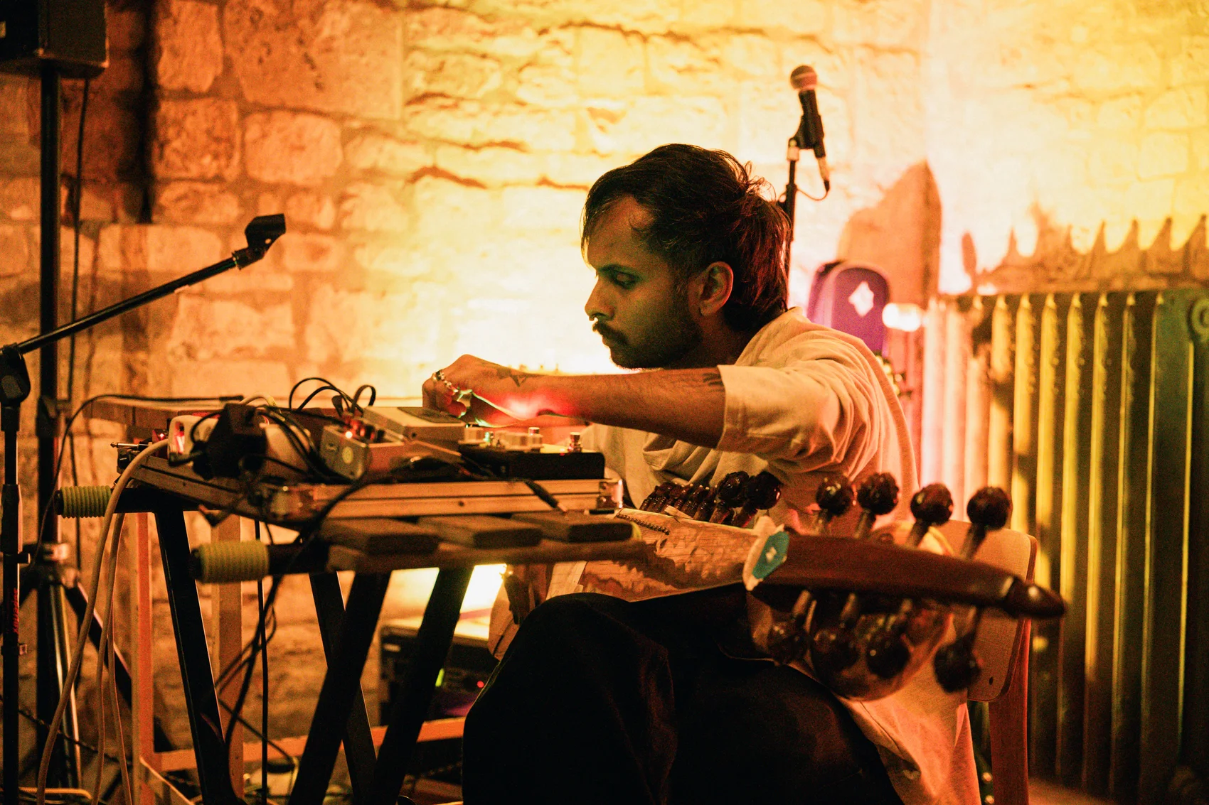 Akshay Gite performing with sarod and electronic equipment